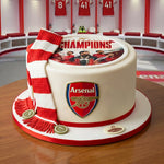 White fondant cake with arsenal champions picture printed on top with arsenal scarf