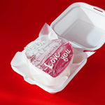 Clear aligner case with 'Love you' message on a red background