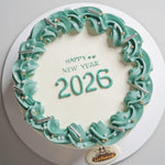 Cake with 'Happy New Year 2026' text and decorative icing on a white background