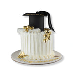 Graduation-themed cake with a black cap and gold decorations on a white background