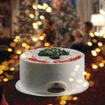 Decorative cake with Christmas tree design on a blurred festive background