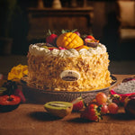 Decorative cake with fruits on a wooden table