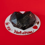 Heart-shaped chocolate cake on a red background with 'be my Valentine' text
