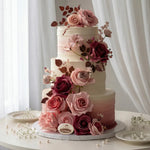 Three-tiered wedding cake decorated with pink and red roses on a white background