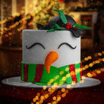 Christmas-themed cake decorated like a snowman with a blurred festive background