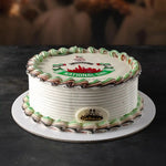Cake with decorative icing and a logo on a dark background