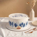 Father's Day cake with blue decorations on a white tablecloth.