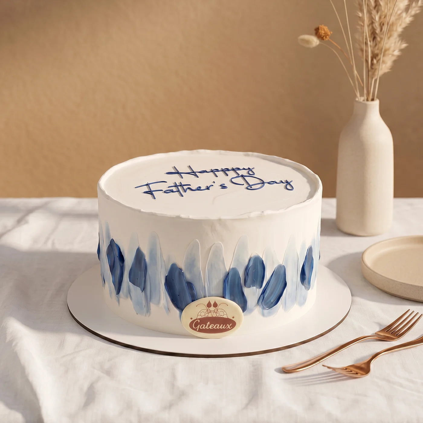 Father's Day cake with blue decorations on a white tablecloth.