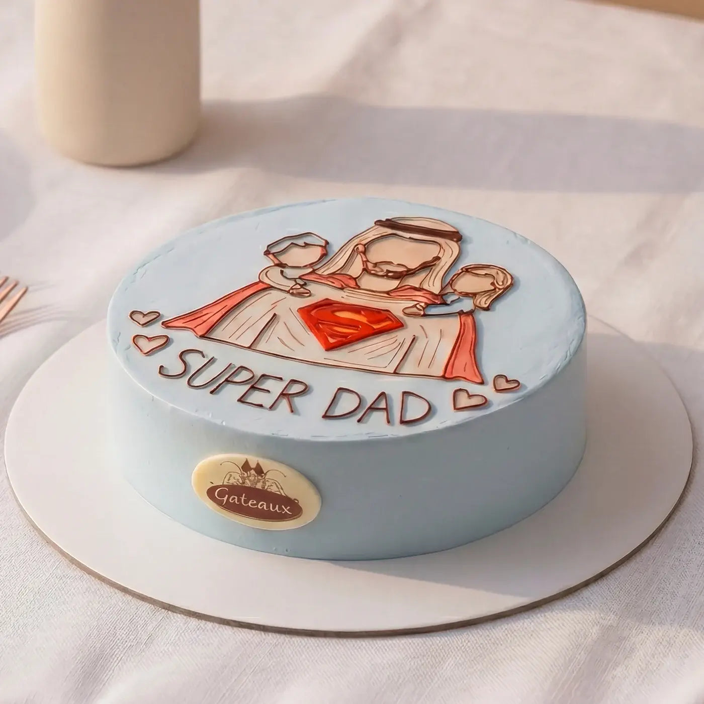 Cake with 'Super Dad' design on a white surface