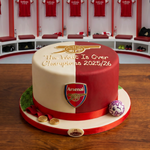 Cake with Arsenal FC logo and text in a locker room setting