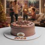 Chocolate cake with 'Galleria' branding in a festive indoor setting with people and decorations.