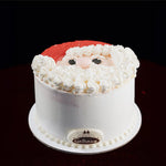 Cake decorated to resemble Santa Claus with a dark background