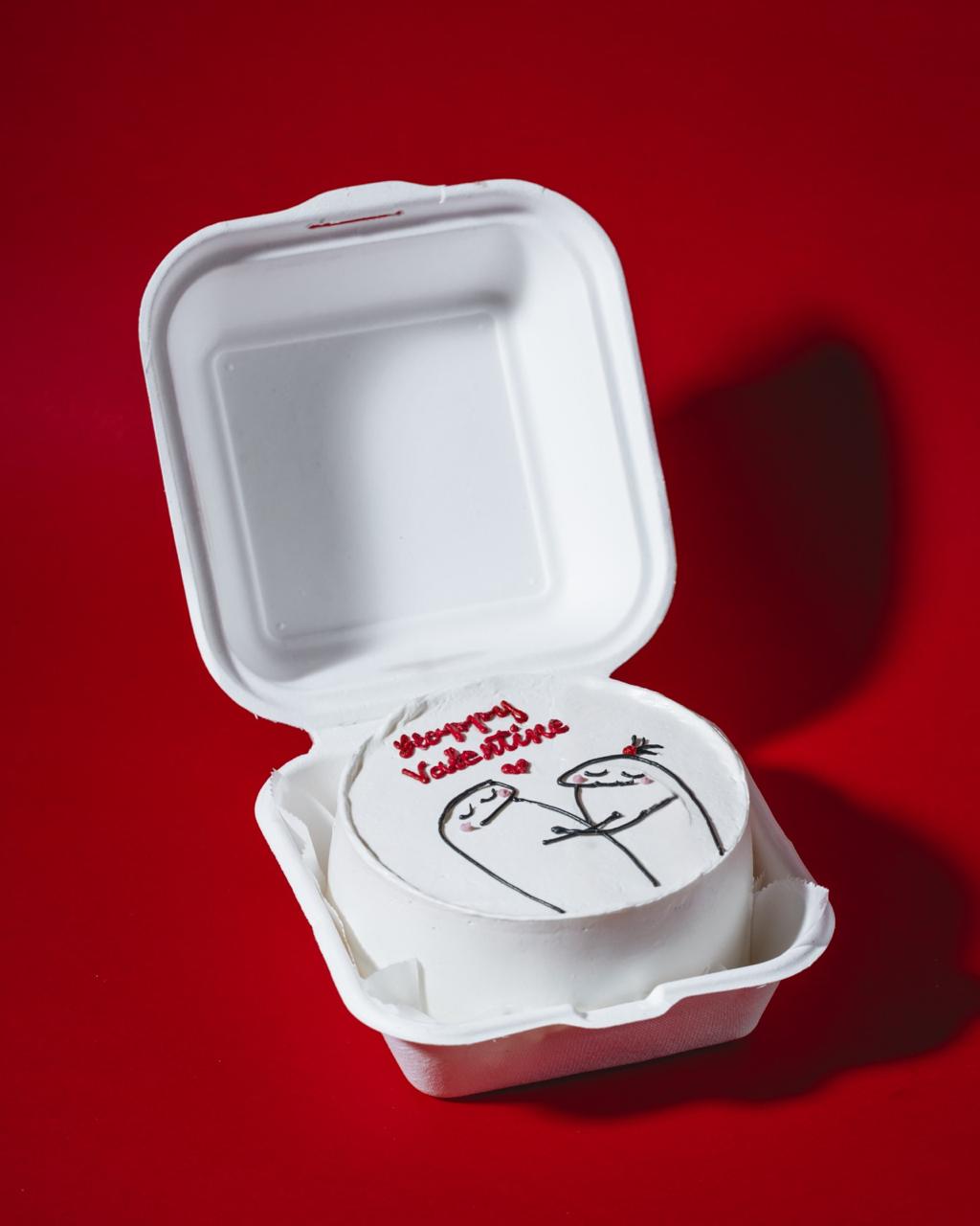 Open take-out container with Valentine's Day design on a red background