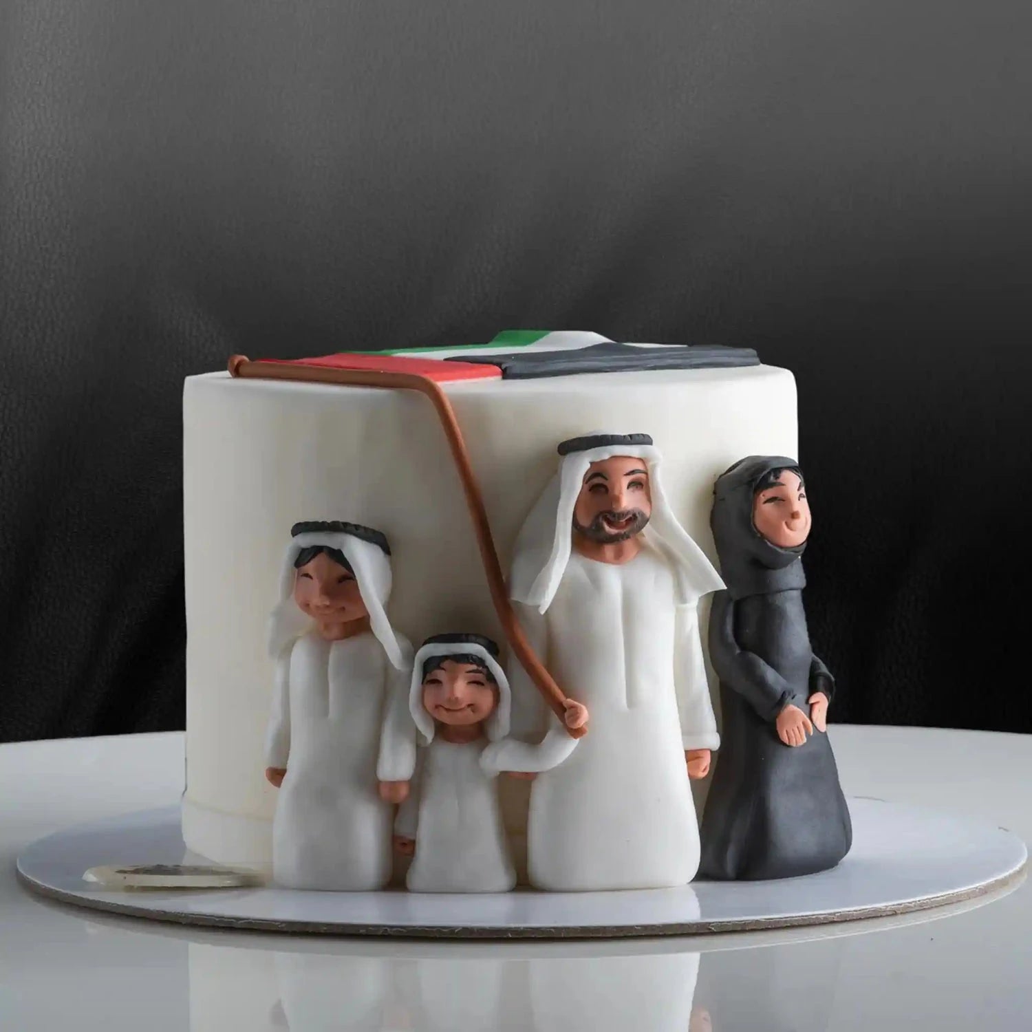 Ceramic box with figurines of a family in traditional attire on a dark background