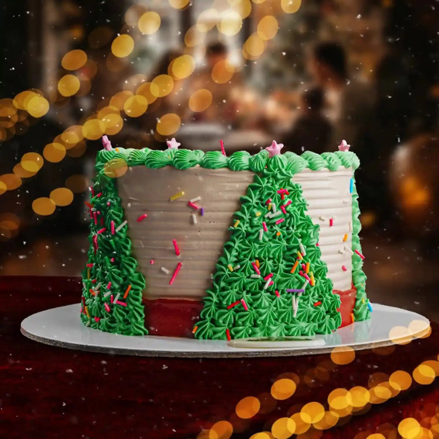 Decorative cake shaped like a house with green and white frosting, set against a festive background with lights.