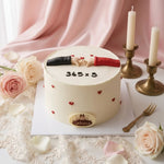 A round white frosted cake decorated with small red hearts, the number equation '365 x 5' on top, and two fondant hands holding hearts. The cake sits on a white board surrounded by pink roses, lace, candles, and a fork against a soft pink draped backdrop.