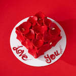 Heart-shaped cake with red roses on a red background with 'Love You' text