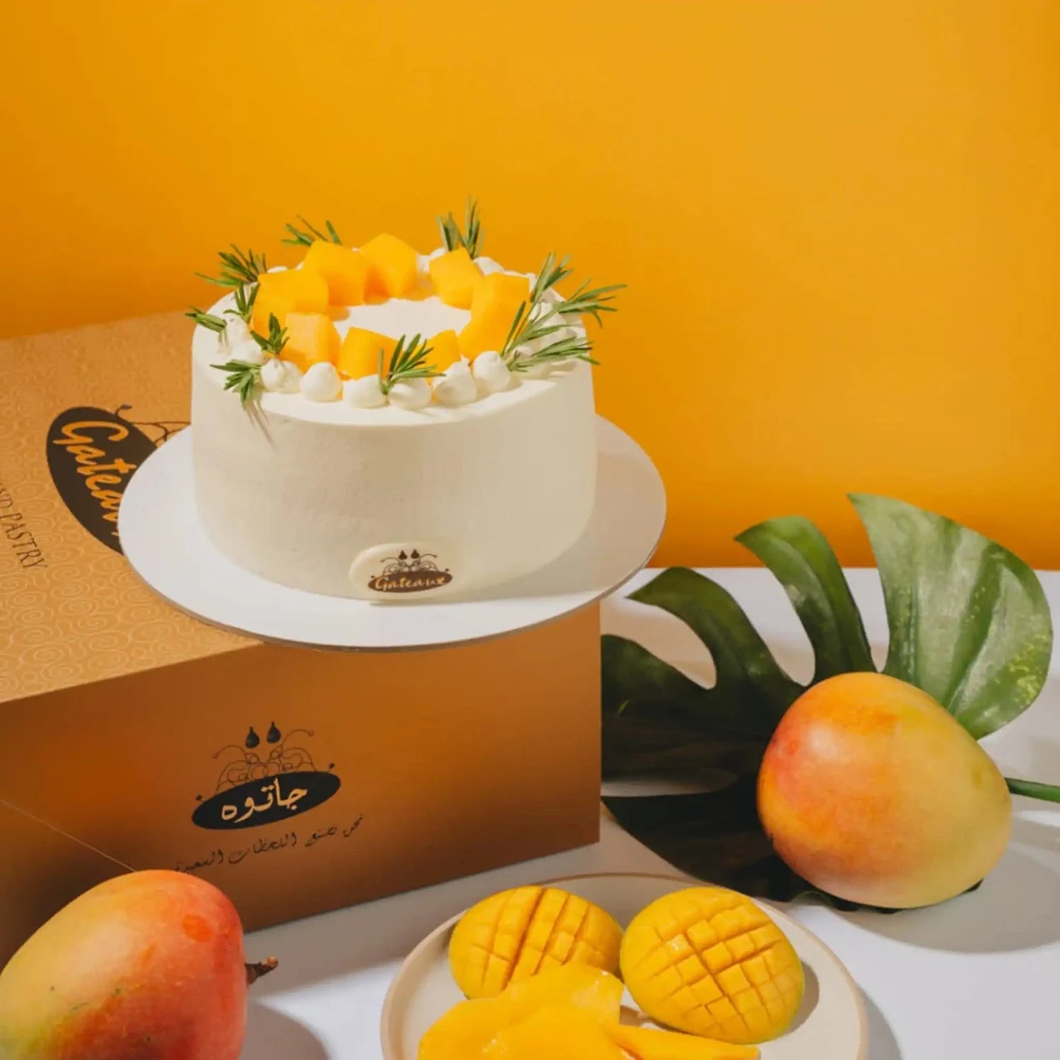 Mango-themed cake with decorative mango pieces on a white surface against an orange background