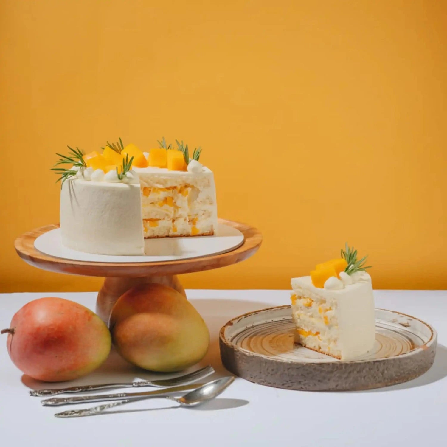White cake with fruit on a wooden stand against an orange background