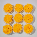Nine cupcakes with yellow frosting on a white background
