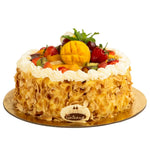 Fruit cake with white frosting and visible brand logo on a white background