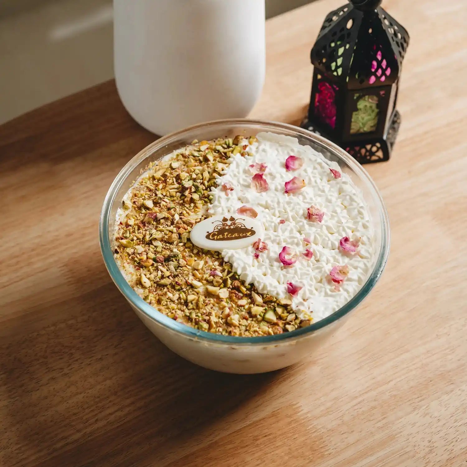 Bowl of dessert with nuts and whipped cream on a wooden table