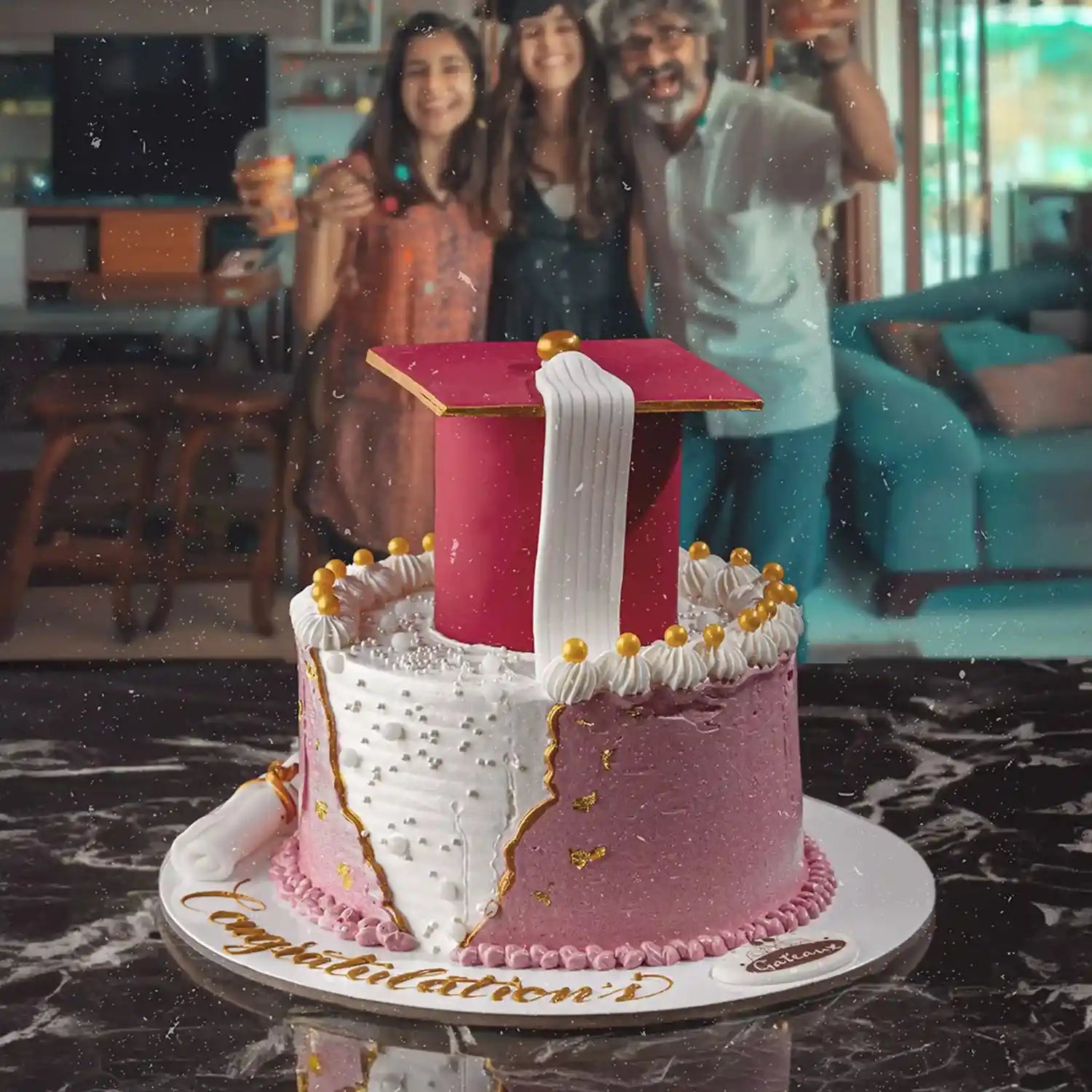 Decorative cake resembling a graduation cap with people in the background