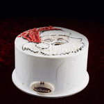 White cake with a face design on a dark background
