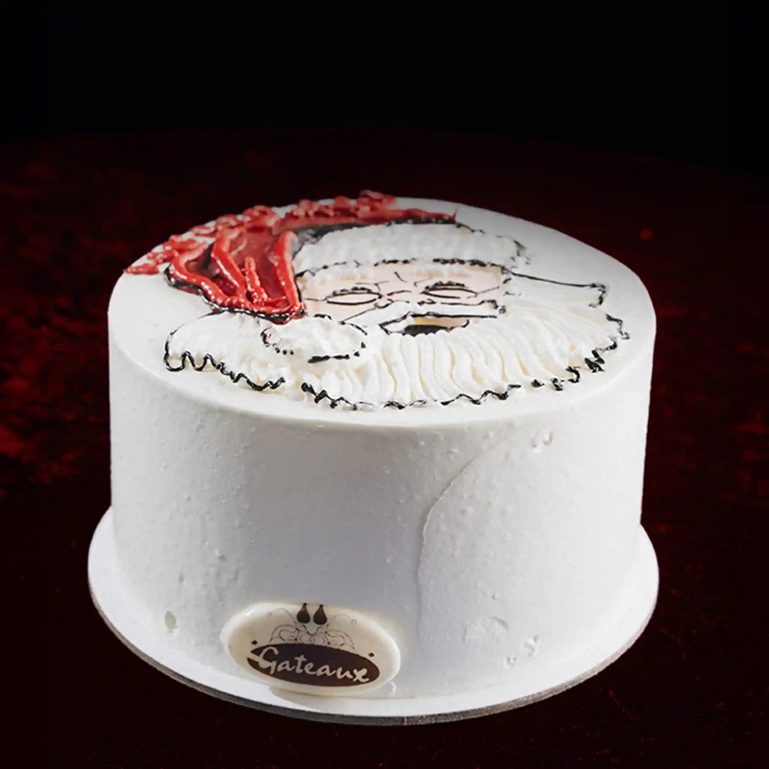 White cake with a face design on a dark background