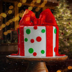 Decorative gift box with red bow on a stand against a festive background