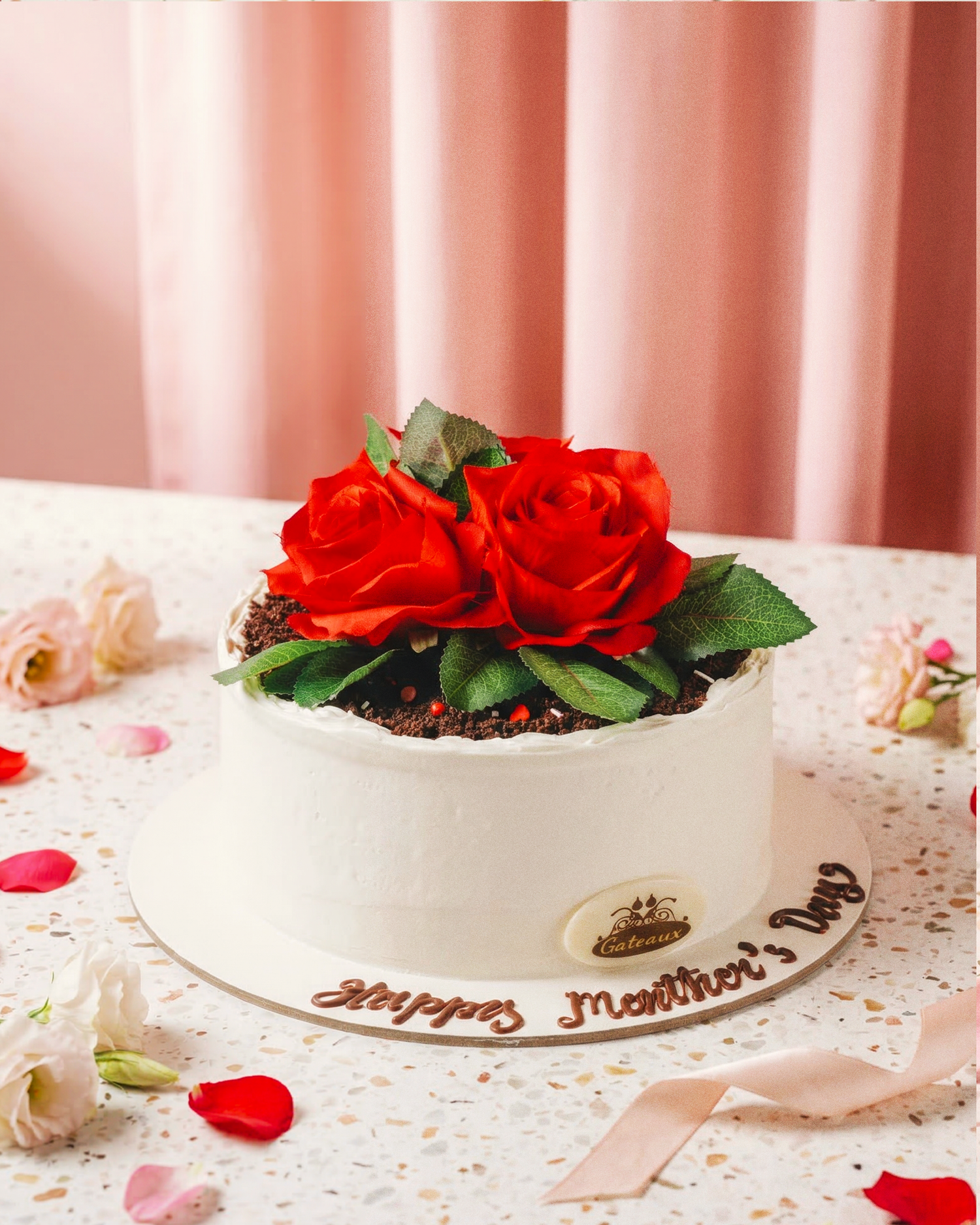 Decorative cake with red roses and green leaves on a light background