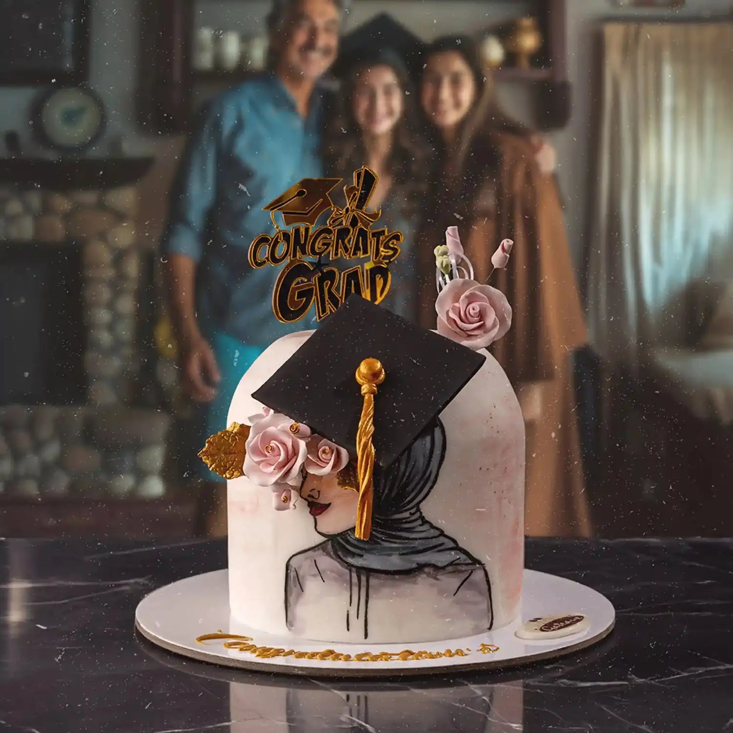 Graduation-themed cake with flowers and a cap, with people in the background.