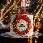 Decorative cake with red and green icing, featuring a bow, on a blurred festive background.
