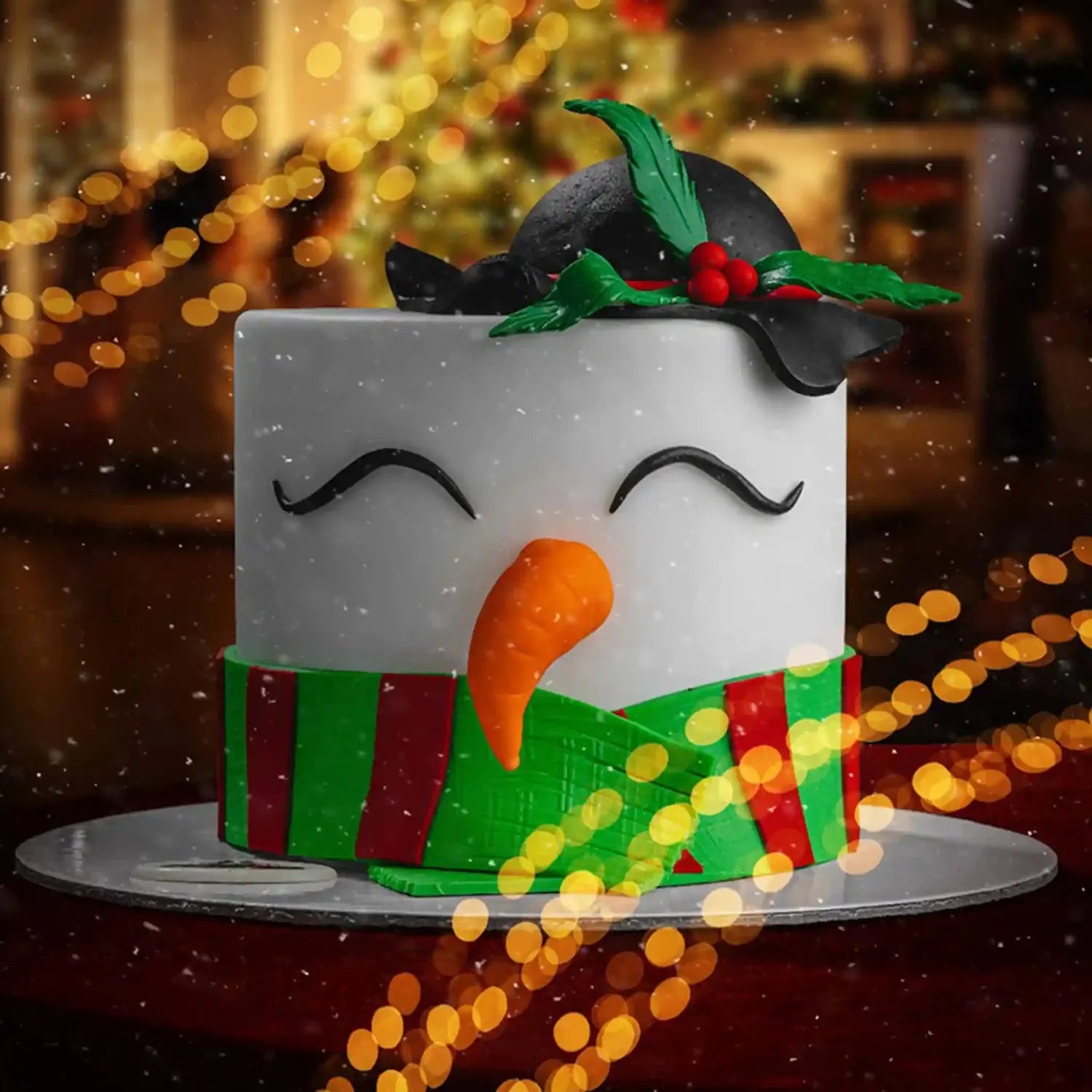 Christmas-themed cake decorated like a snowman with a blurred festive background