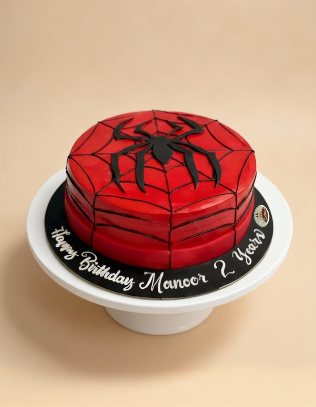 Spider-Man themed birthday cake on a beige background