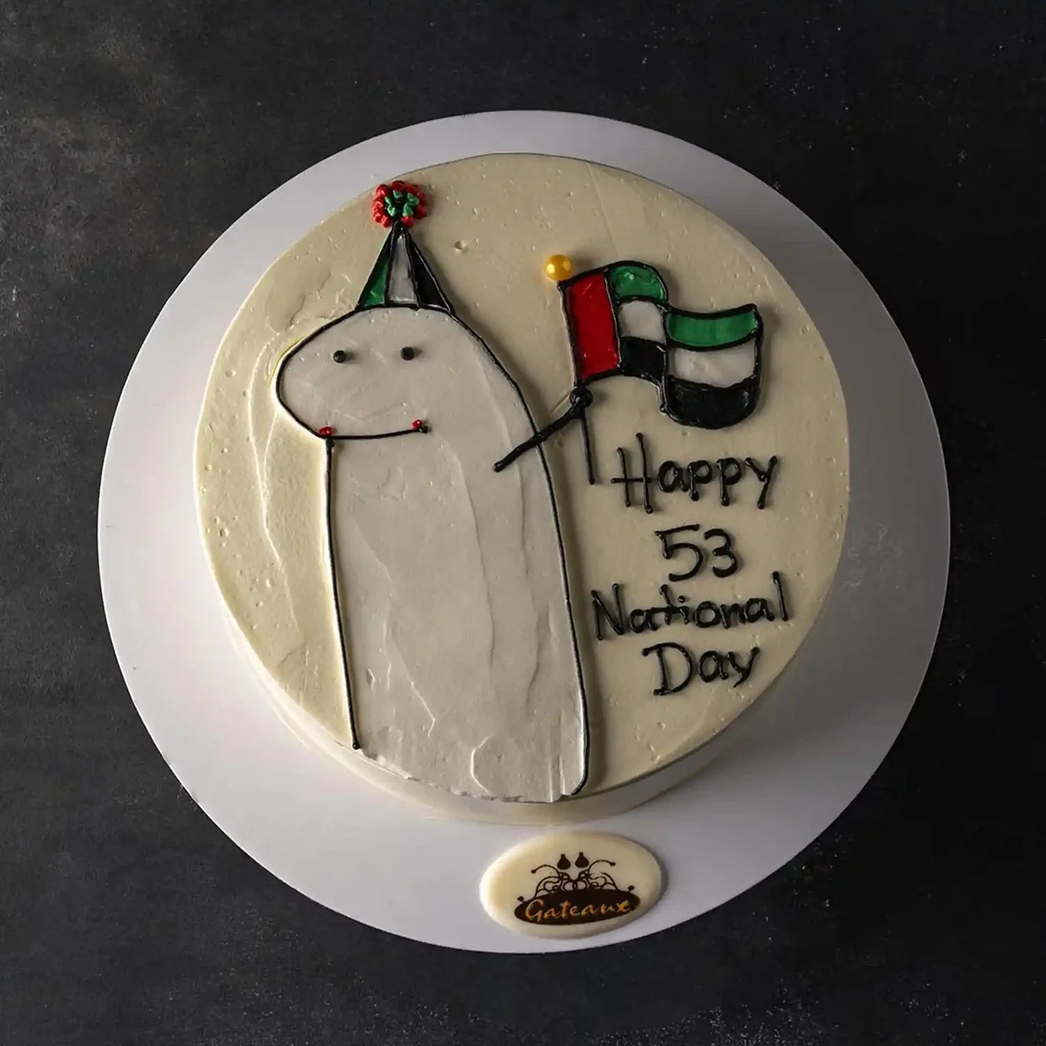Cake with a character holding a flag and 'Happy 53 National Day' text on a dark background