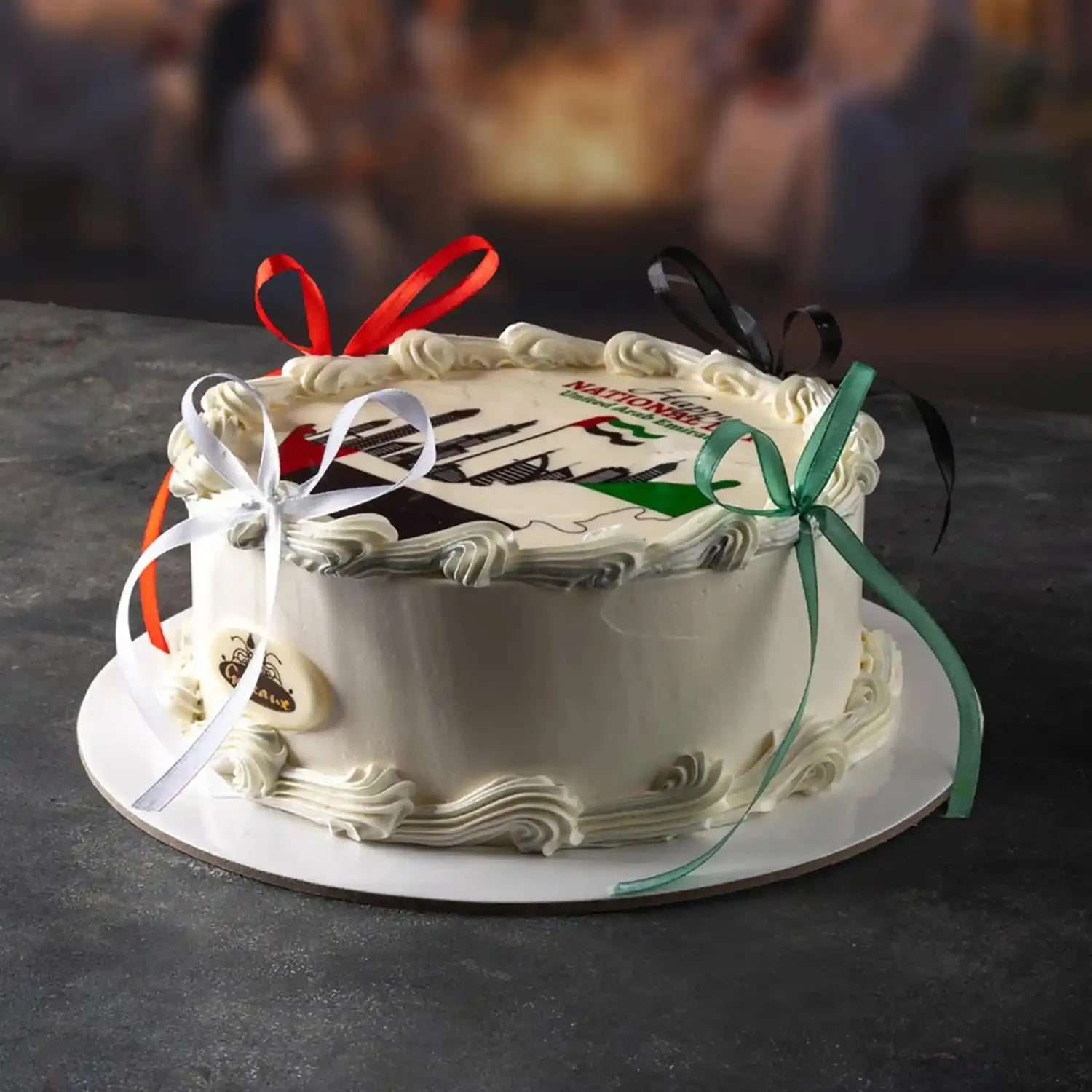 Decorated cake with ribbons on a dark surface