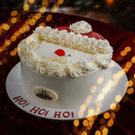 Decorative cake with a Santa hat design on a blurred festive background