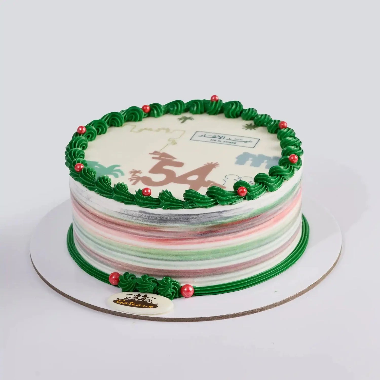 Decorative birthday cake with green icing and colorful stripes on a white background