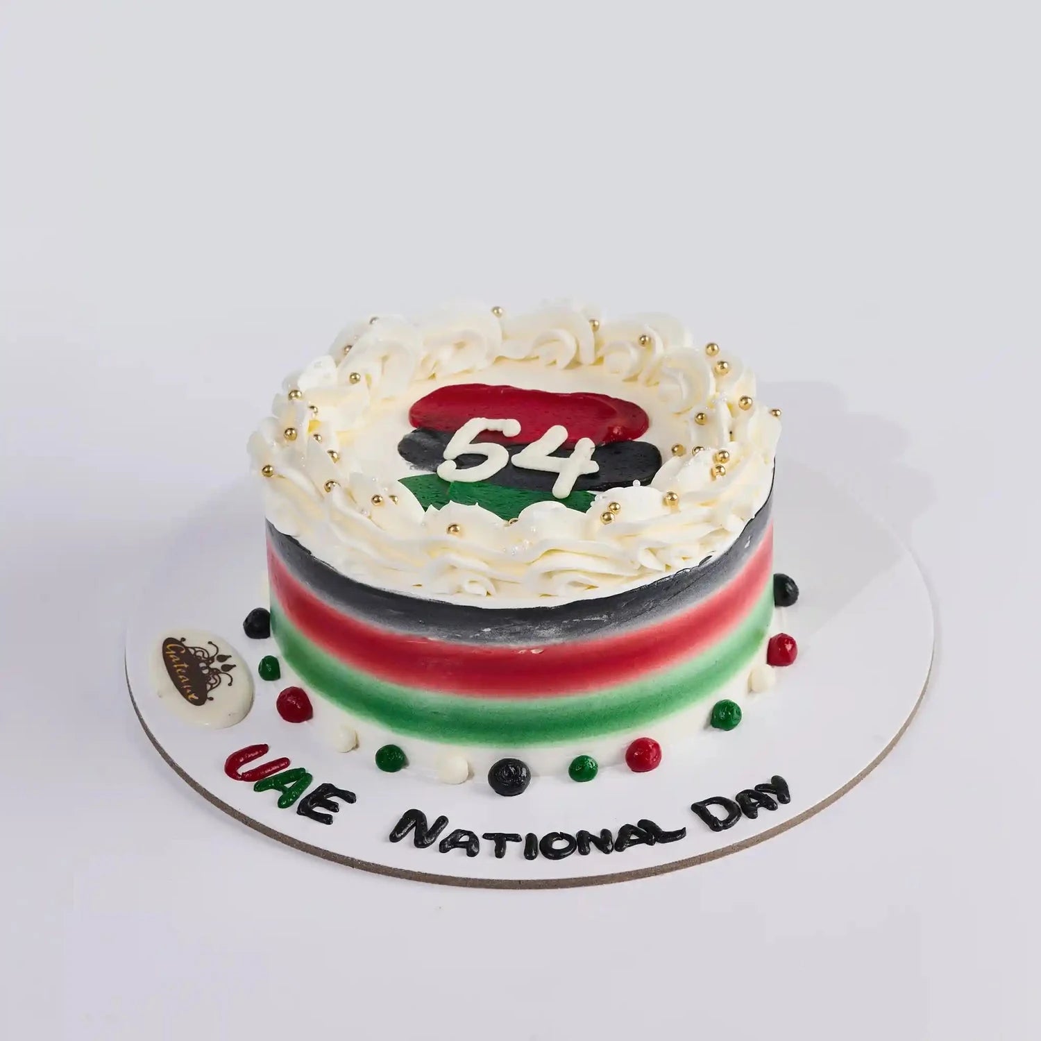 Cake with UAE national colors and '54' on a white background