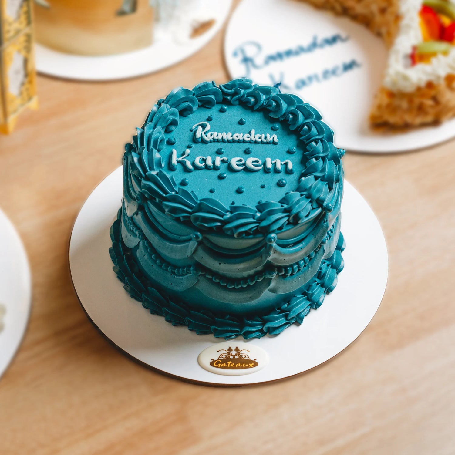 Blue cake with 'Ramadan Kareem' text on a wooden table