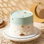 Decorative cake with moon and star designs on a textured surface