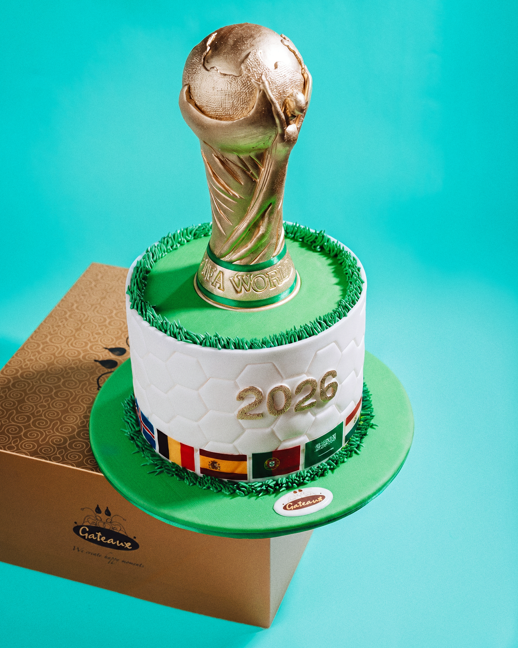 Cake with a World Cup trophy design on a turquoise background
